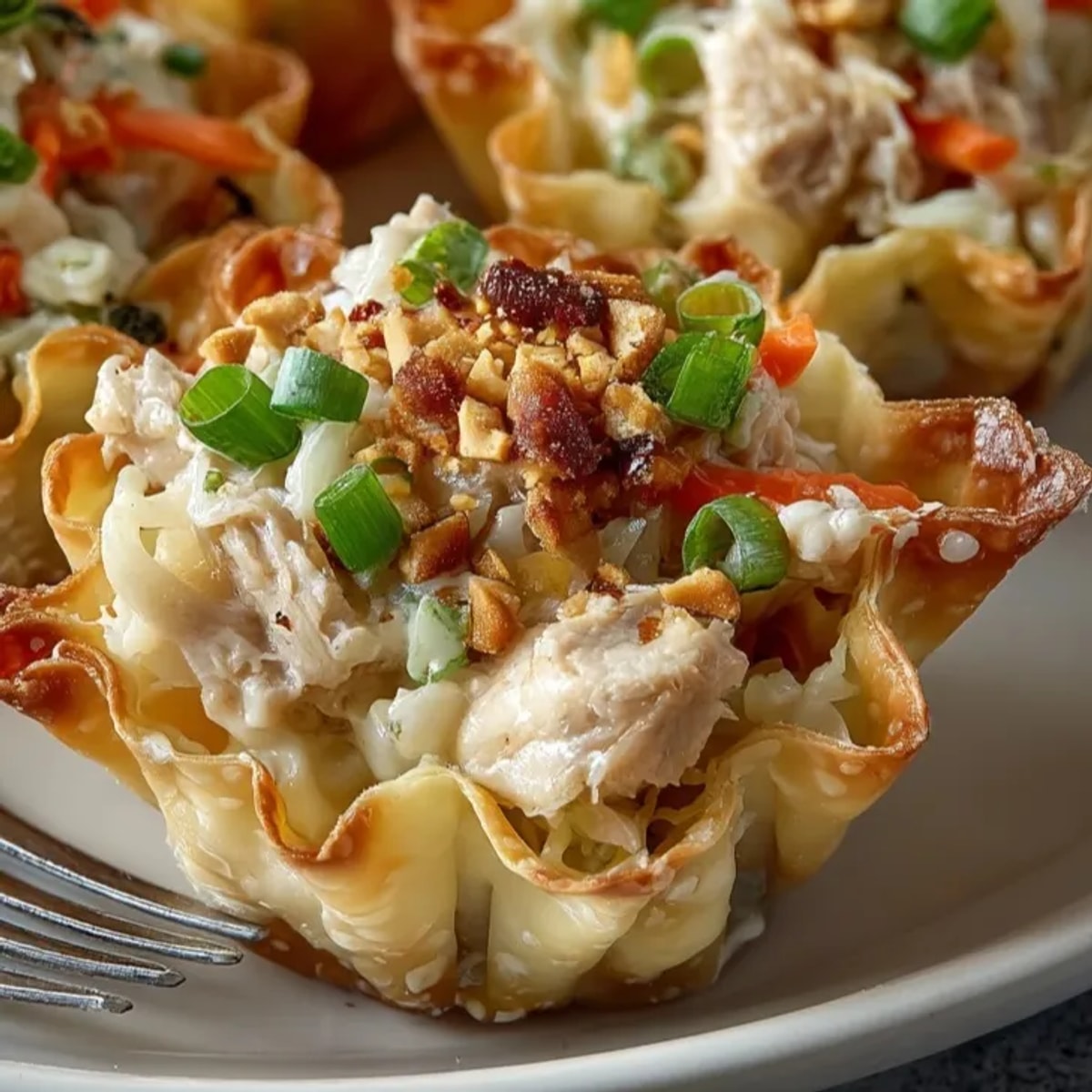 Golden, crispy Peanut Chicken Wonton Cups, savory aroma fills the kitchen air, ready to serve.