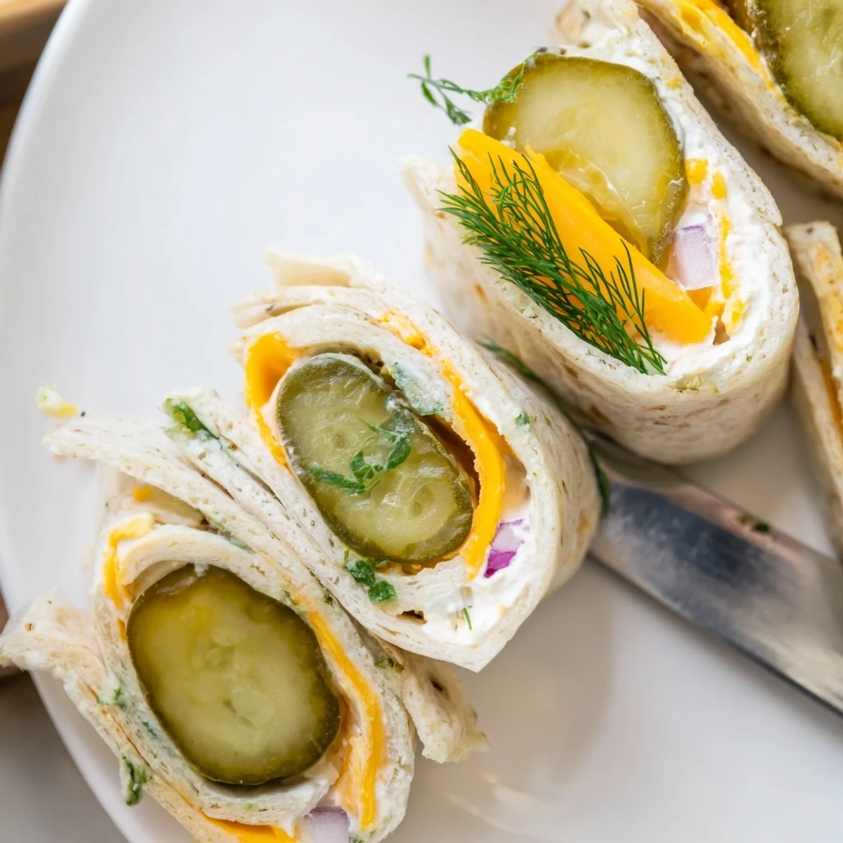 Crispy Pickle-in-a-Blanket snack rolled with creamy cheese and soft tortillas.  