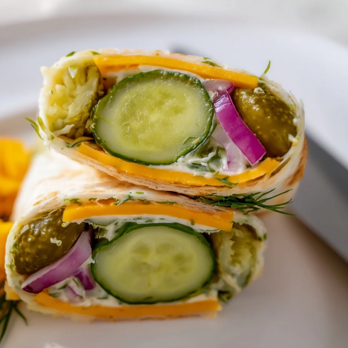 Tangy Pickle-in-a-Blanket bites sliced for easy party serving and delicious snacking.  