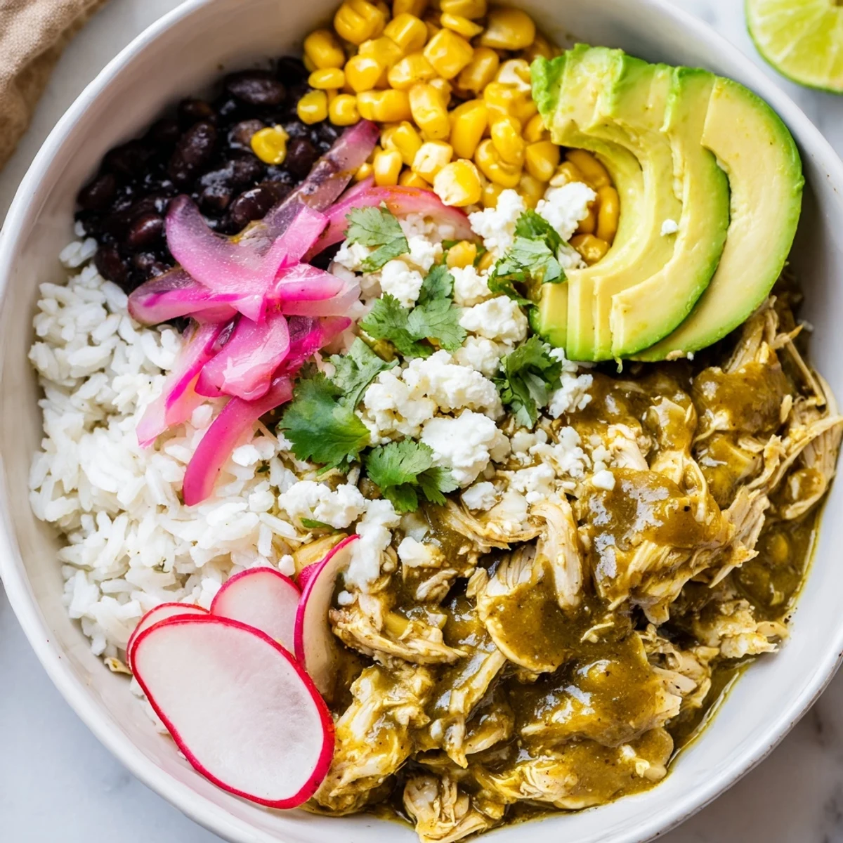 Imagine a hearty Green Enchiladas Rice Bowl with avocado slices, ready for a satisfying, flavorful dinner.
