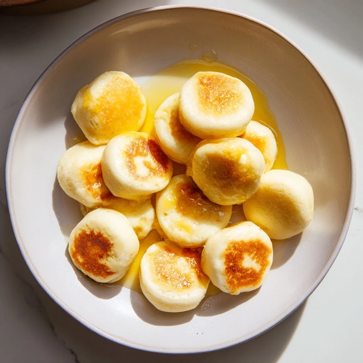 Fluffy mini Pancake Cereal, piled high, ready to be enjoyed with fresh berries and milk.