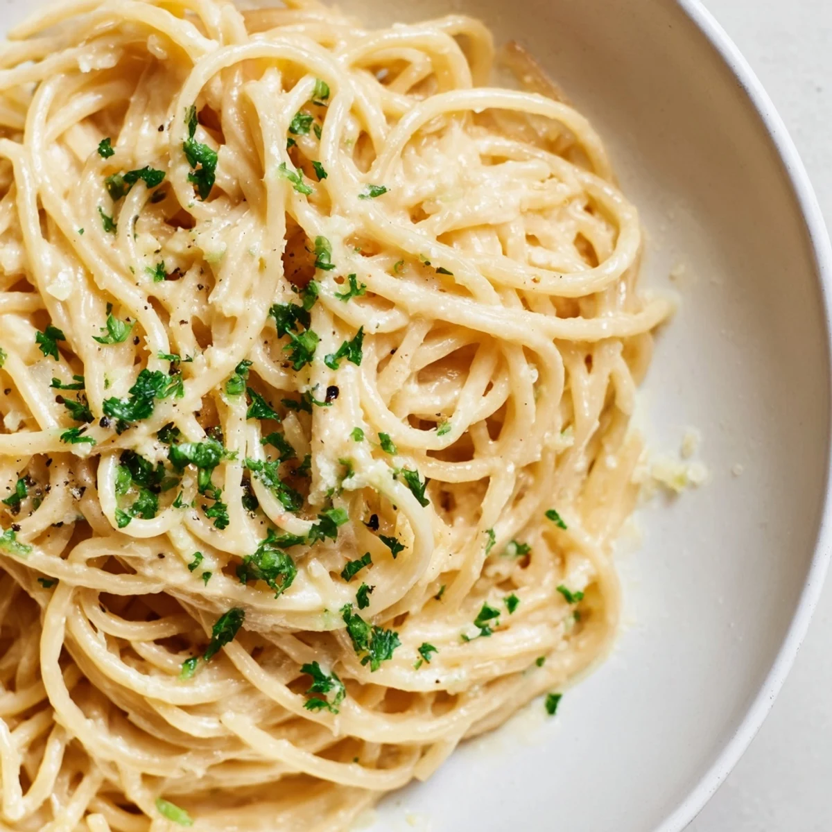 Creamy Three-Cheese Spaghetti, a rich and comforting pasta dish, steaming and ready to serve.
