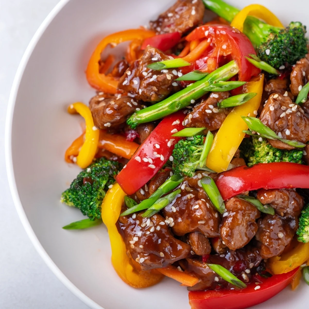 Steaming Chicken Stir-Fry with Vegetables and Rice, a colorful dish, ready for your plate.