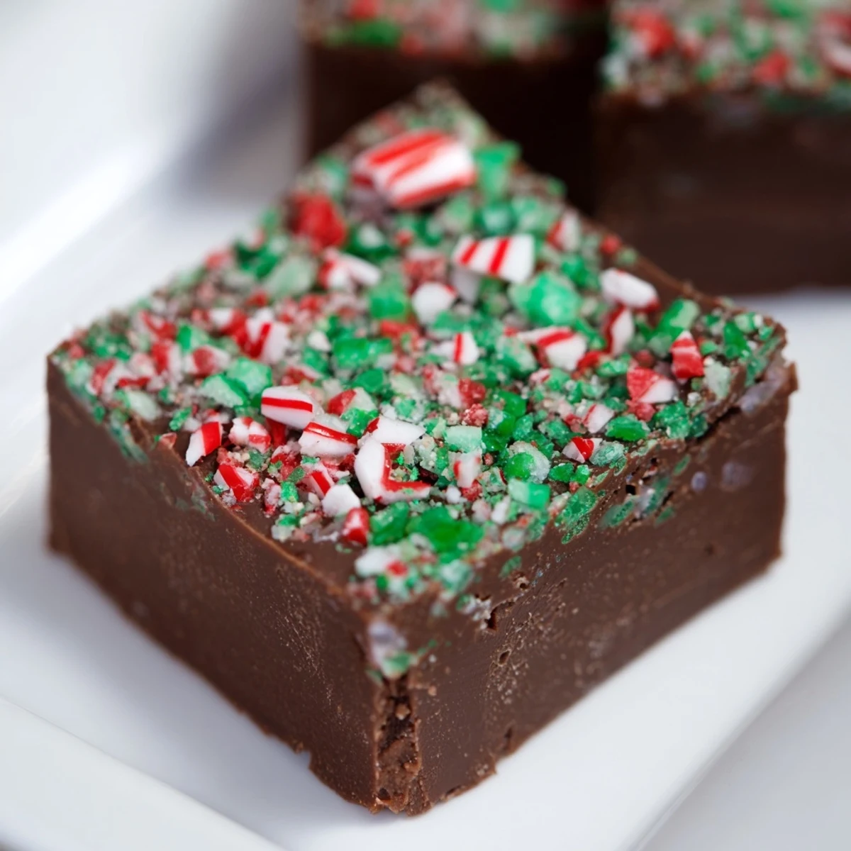 Smooth, glossy surface showing perfectly cut 3-Ingredient Christmas Fudge Squares, ready for sharing and eating.