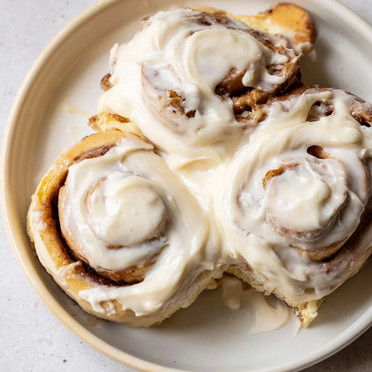 A close-up of golden brown Viral TikTok Heavy Cream Cinnamon Rolls, freshly baked and ready to eat.