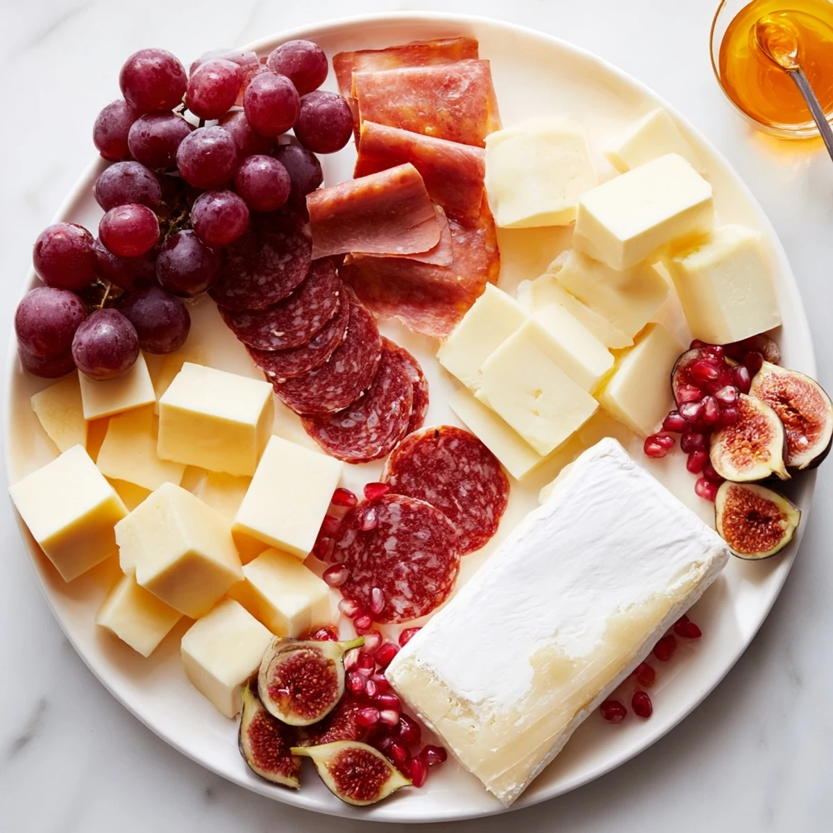 A beautifully arranged Twelve Days of Christmas snack board featuring an array of cheeses and crackers.
