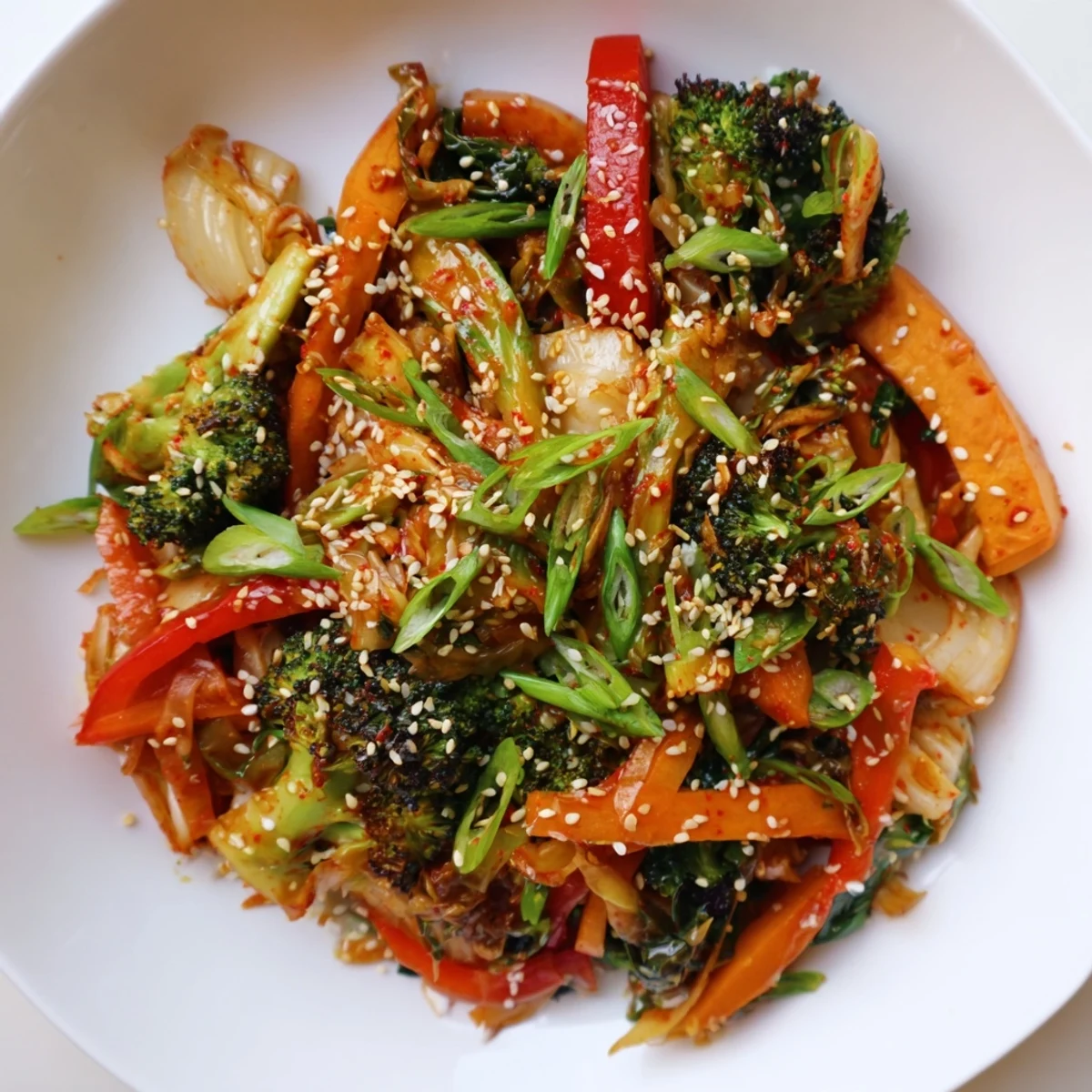 The finished Comforting Fermented Veggie Winter Stir-Fry served steaming in a skillet, garnished with fresh green onions and toasted sesame seeds for a quick, healthy dinner.