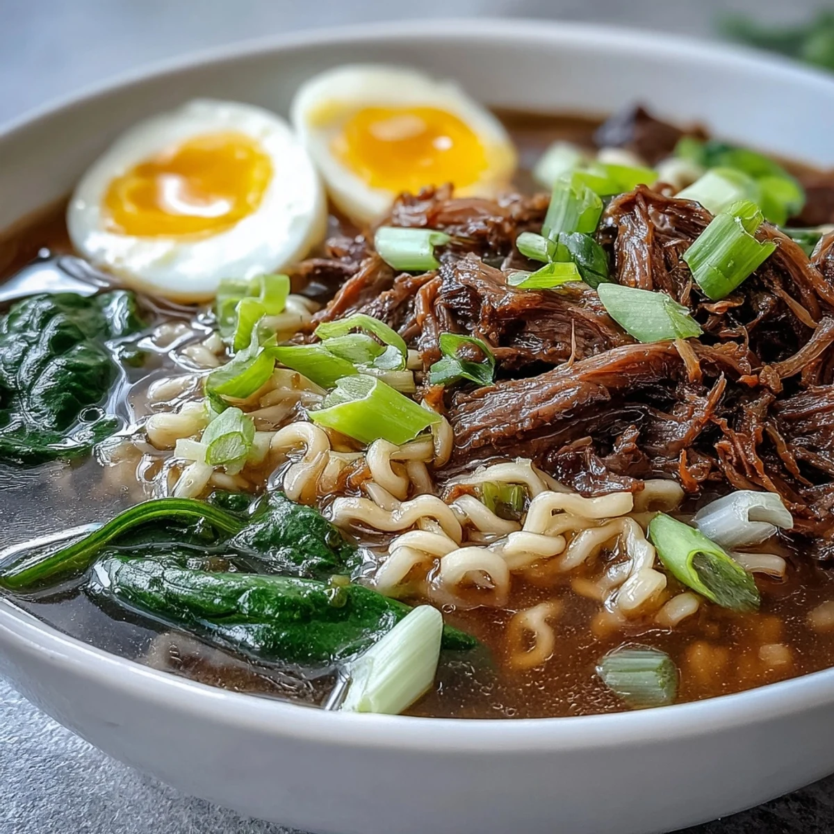 A steaming bowl of homemade Slow Cooker Beef Ramen Noodles with chunks of beef and fresh ginger, showcasing the aromatic broth and savory garnishes on a wooden table.