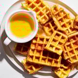 A close-up of crispy waffle quarters ready to dip, a yummy recipe with maple syrup.
