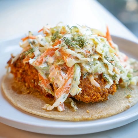 Crispy Buffalo Chicken Smash Burger Tacos sizzling on the griddle, ready to be flipped and filled with slaw.
