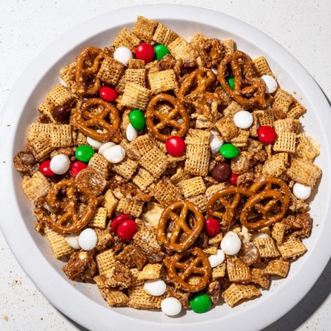 Golden-brown Holiday Mix in a holiday bowl, a blend of sweet and savory textures.