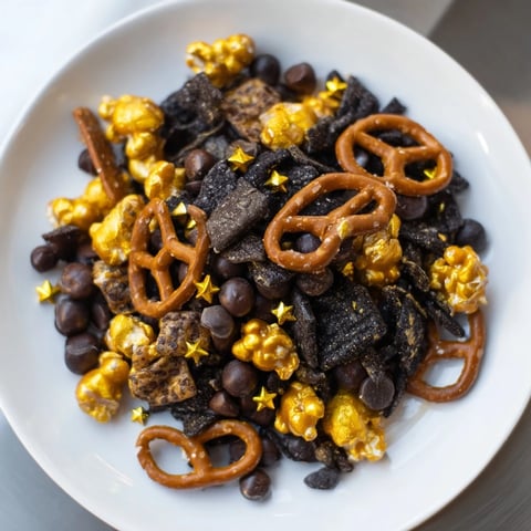 Golden and black Midnight Snack Mix, a glistening, crunchy treat perfect for a New Year's celebration.