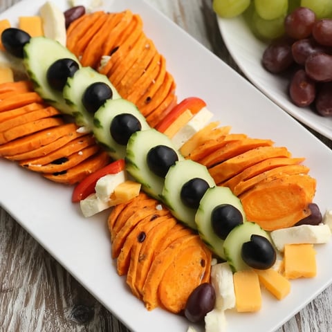 Beautifully arranged Monarch Butterfly Wings appetizer: a party platter with vibrant orange and black elements.