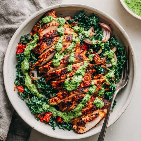 Flavorful Chimichurri Grilled Chicken Bowl with vibrant greens and roasted tomatoes, perfect for dinner.  