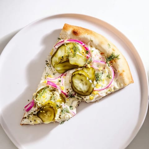 Savory Pickle Pizza garnished with fresh dill, perfect for adventurous eaters.  