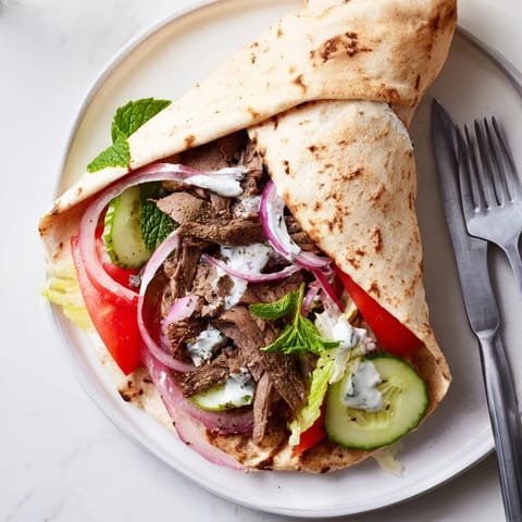 Mouthwatering beef shawarma wraps served with tangy yogurt sauce and vibrant vegetables.  