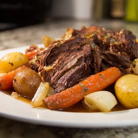 Fork-tender Sunday Pot Roast, beautifully seared, surrounded by flavorful roasted carrots and potatoes.