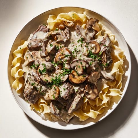 A delicious close-up of Creamy Mushroom Beef Stroganoff, showing tender beef and hearty mushrooms in a creamy gravy.