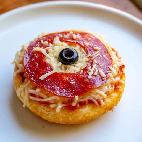 Santa Belt Mini Pizza Bites showcased: golden crusts, pepperoni belts, cheese, and olives.