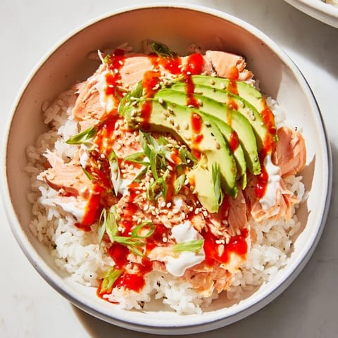 Flaky salmon glistens atop seasoned rice in this vibrant Classic Salmon Rice bowl.