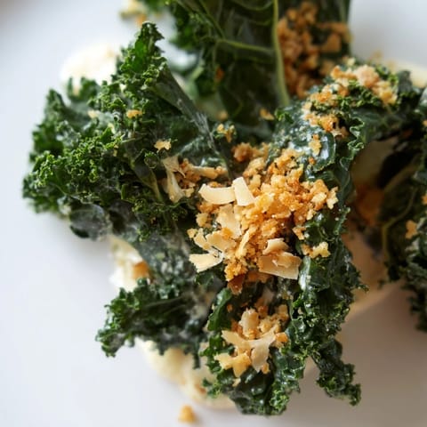 Garlic Parmesan Kale Salad tossed with shaved Parmesan, lemon juice, and crunchy panko for an easy, flavorful American side dish.