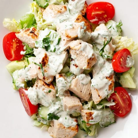 Tender grilled chicken cubes glisten with creamy jalapeño ranch dressing in this hearty Jalapeño Ranch Chicken Salad, served over crunchy greens.