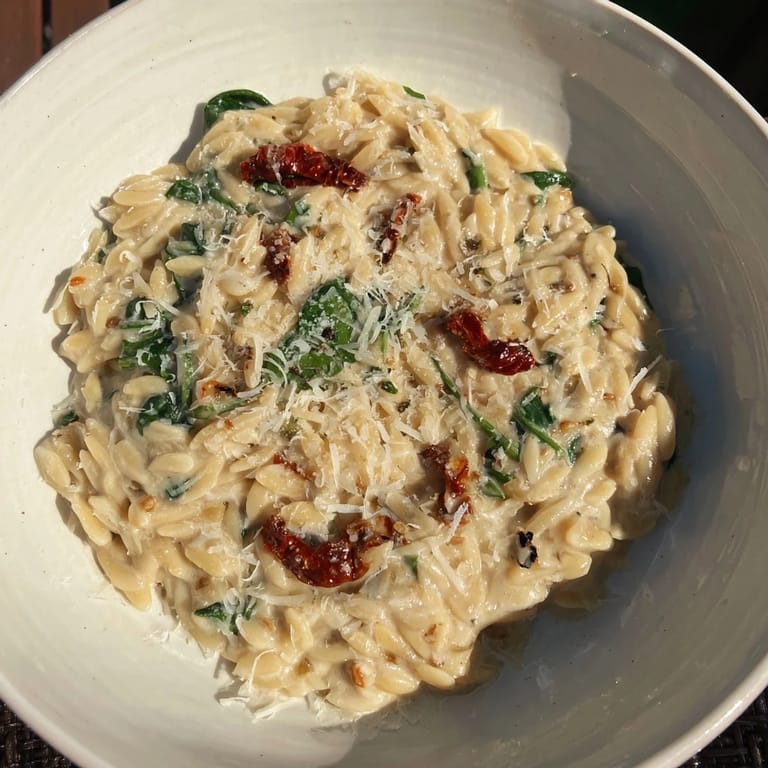 This vegetarian Creamy Tuscan Orzo Bowl features perfectly cooked orzo in a creamy sauce.