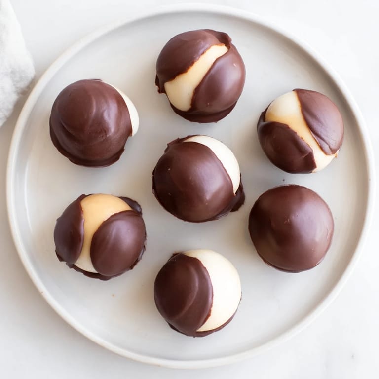 Homemade Peanut Butter Buckeyes arranged on a baking sheet, offering a sweet and classic American treat for any occasion.