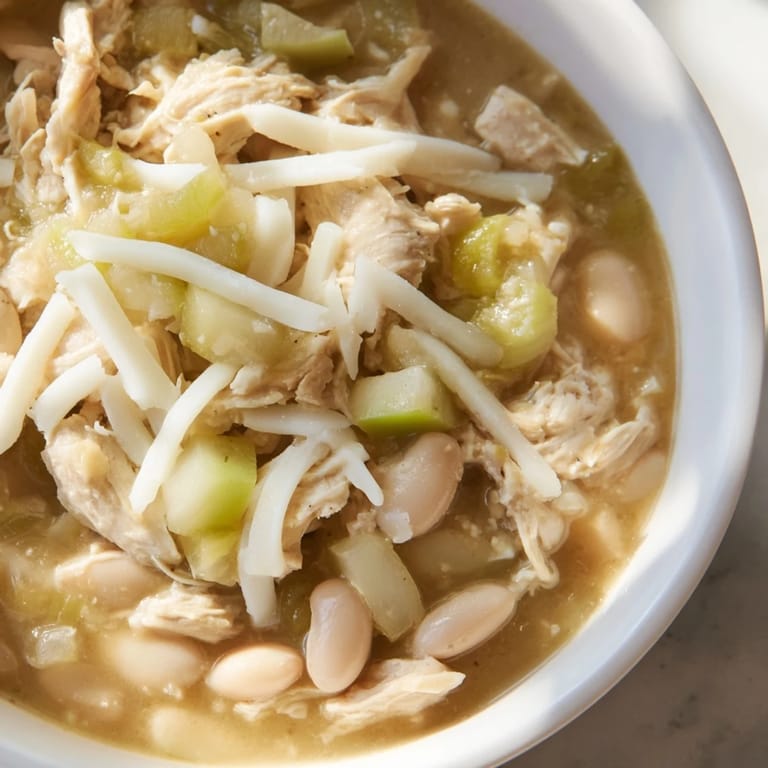 A close-up of a bubbling pot of flavorful 35-Minute White Cheddar Apple Chicken Chili, offering a warm and comforting meal.