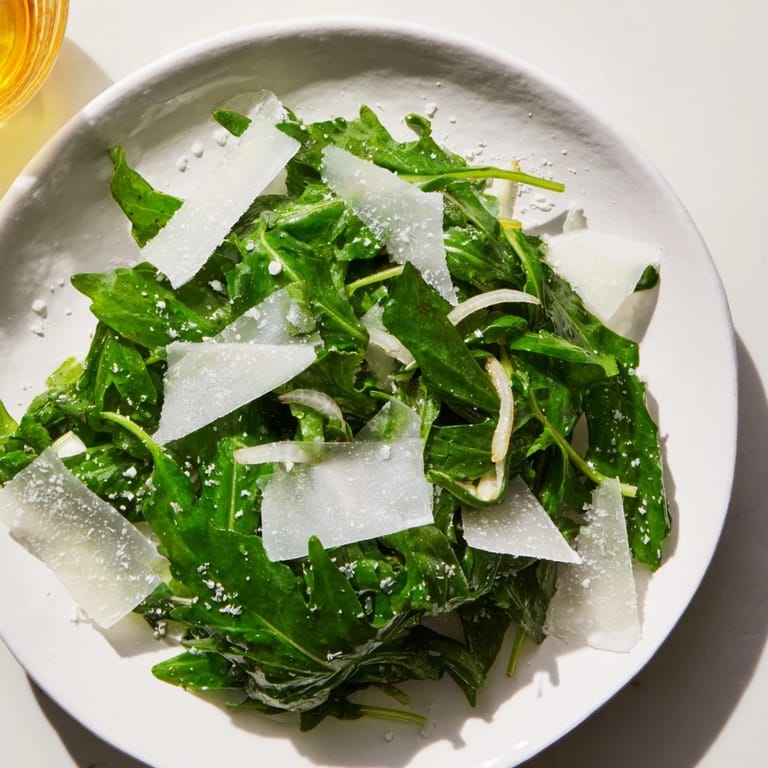 This easy arugula salad with lemon dressing showcases peppery greens, ready to enjoy.
