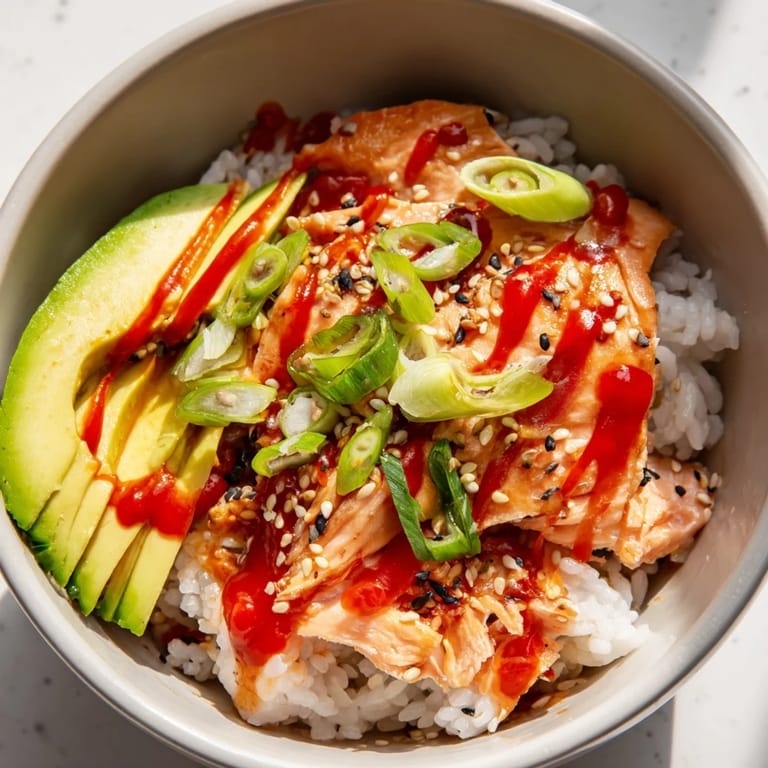 A quick, easy Classic Salmon Rice meal served with nori, sesame seeds, and a wedge of lime.
