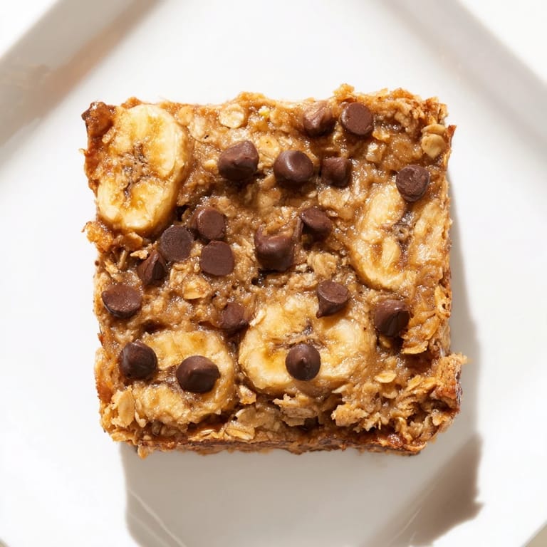 Fluffy baked oats, like cake, with a soft interior, topped with optional chocolate chips, a delicious and easy breakfast.