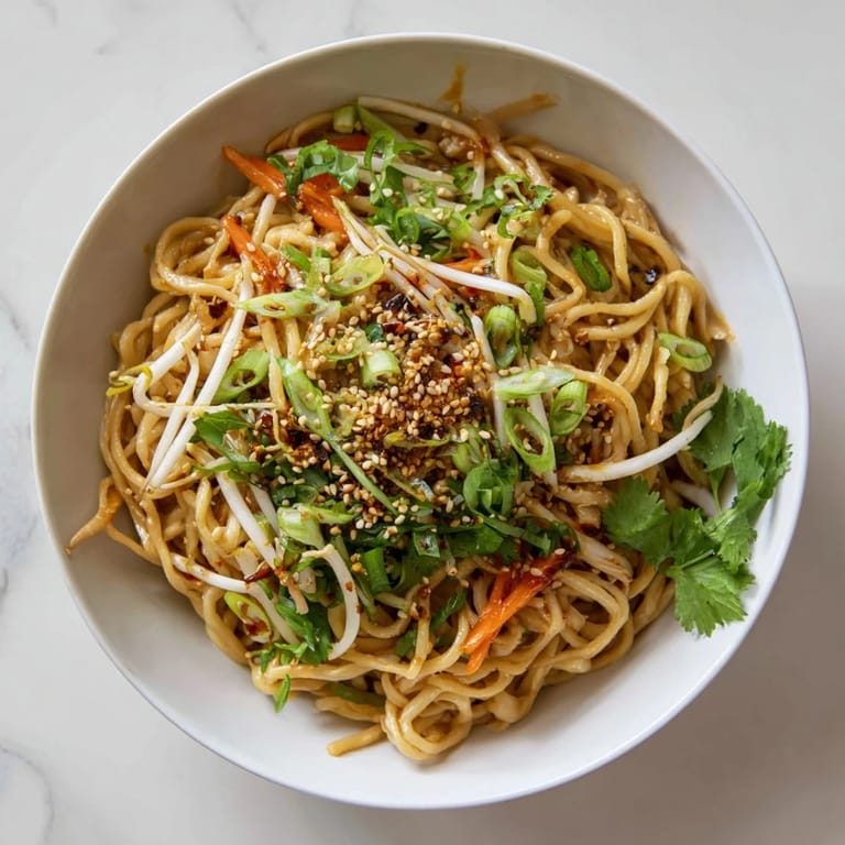 Quick and savory Asian Garlic Noodle Bowl served with optional chili slices and cilantro.